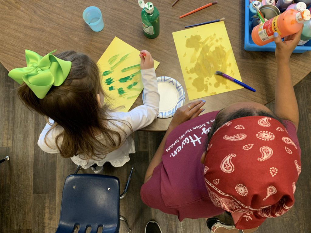 child painting with Healing Haven ABA Therapist