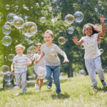 kids playing with bubbles in summer