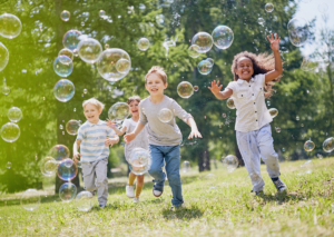 kids playing with bubbles in summer