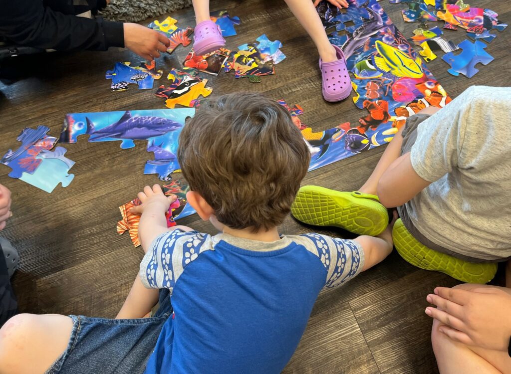 Clients participate in group activity during social group in Young Learners Clinic. 