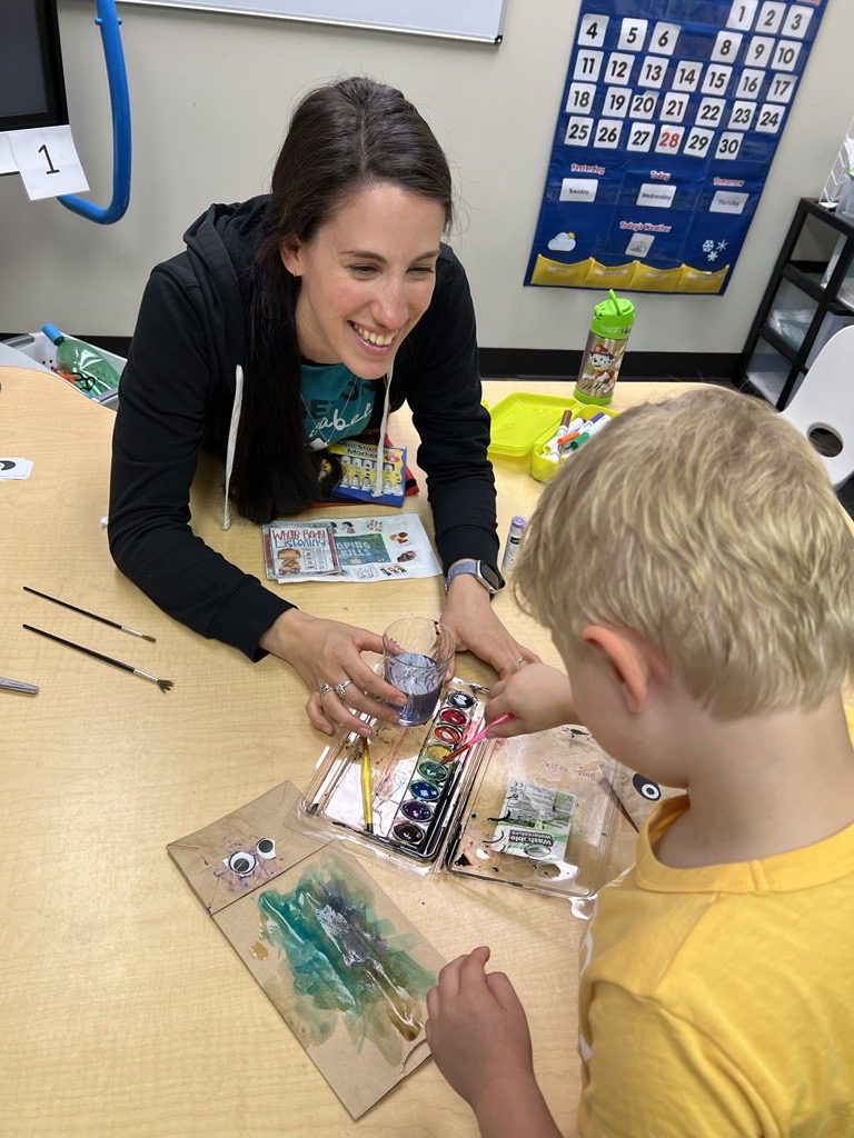 Group instructor leads social group in Early Intervention Clinic. 